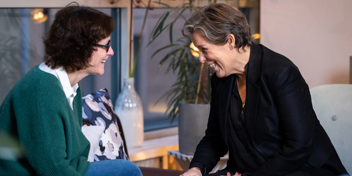 Two people laughing with each other
