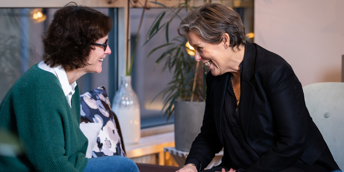 Two people laughing with each other